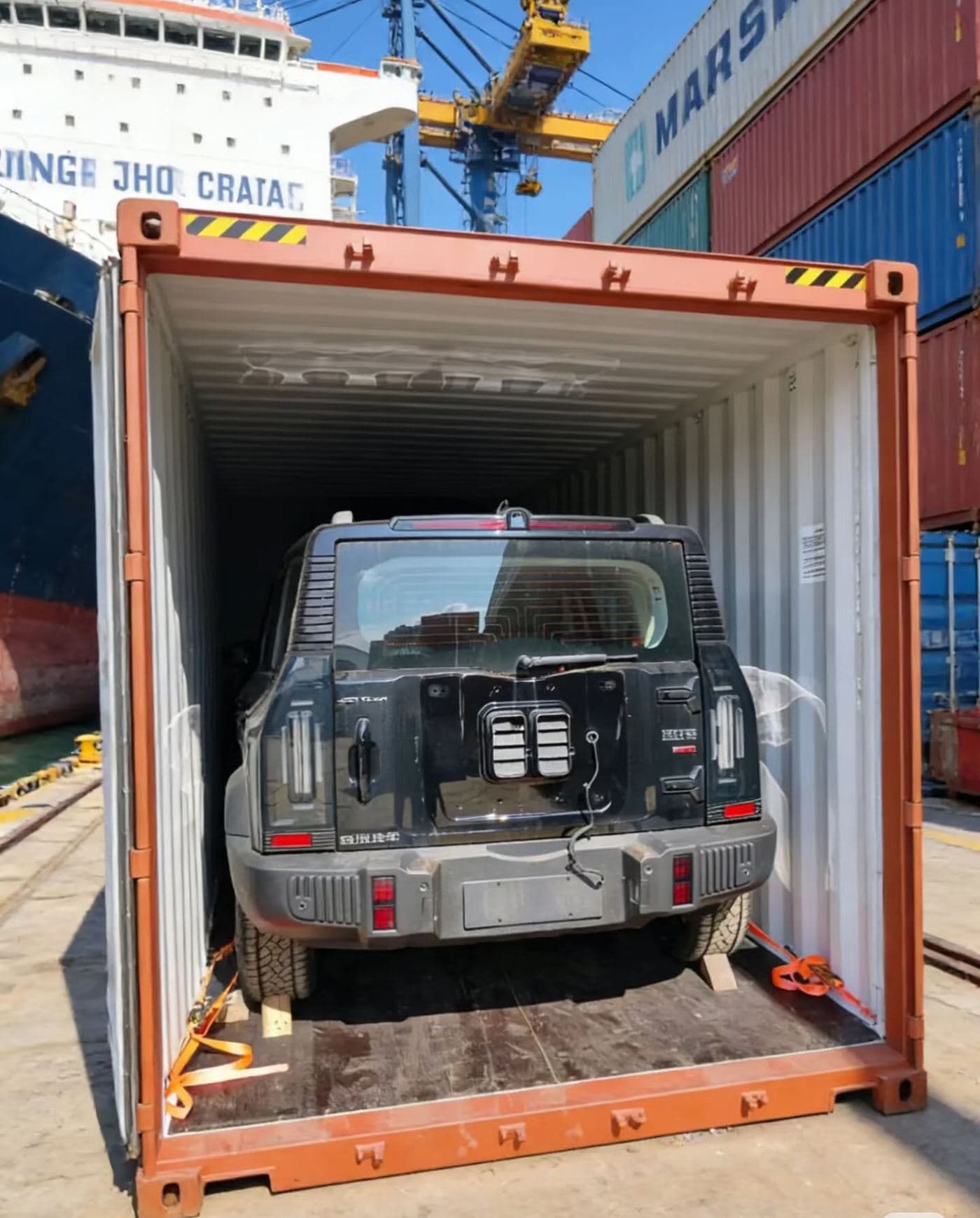 SUV strapped down inside a shipping container at the port